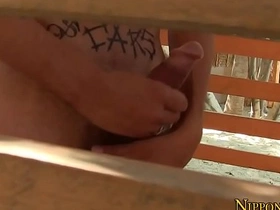 Gay Asian man masturbates outdoors and ejaculates.