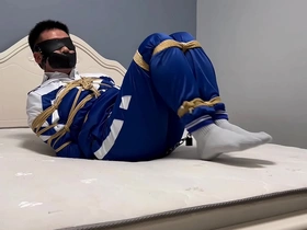Young Asian man with short hair is tied up, gagged and blindfolded in this gay bondage video.