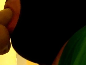 Gay man in hoodie sucks on a dildo.