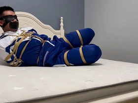 Young Asian man in hogtie bondage and blindfold in a homemade video.