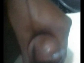 Gay African man pleasuring himself and ejaculating while stroking his cock.