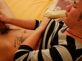 Young Asian man masturbates in bed.