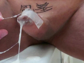 Gay masturbation with an uncut chub cock in a tape cage