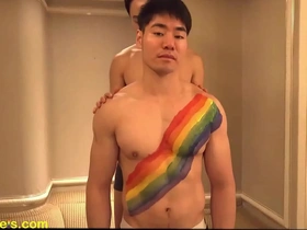 Steamy scene of sexy models painting muscular chests with an emphasis on nipple play and edging.