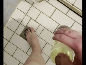 Gay man enjoys golden shower with glass of pee