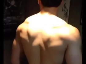 Young Asian man showing off his muscles.