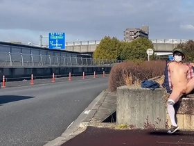 Mayu-chan, a female crossdresser, gets some thrill from being exposed on the roundabout’s sidewalk on a national road during the day when cars have to slow down.