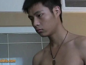 A slim and Asian boy masturbates.