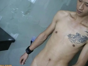 Young Asian man with a big cock masturbates while in bondage